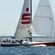 A racing yacht filled with passengers sailing the open waters
